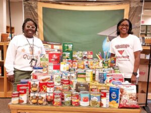 2 ladies with assorted canned goods