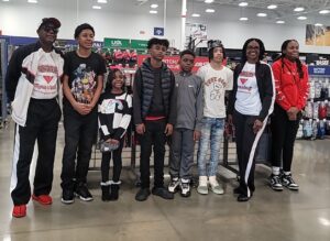 A group of young people posing for a picture in a store.