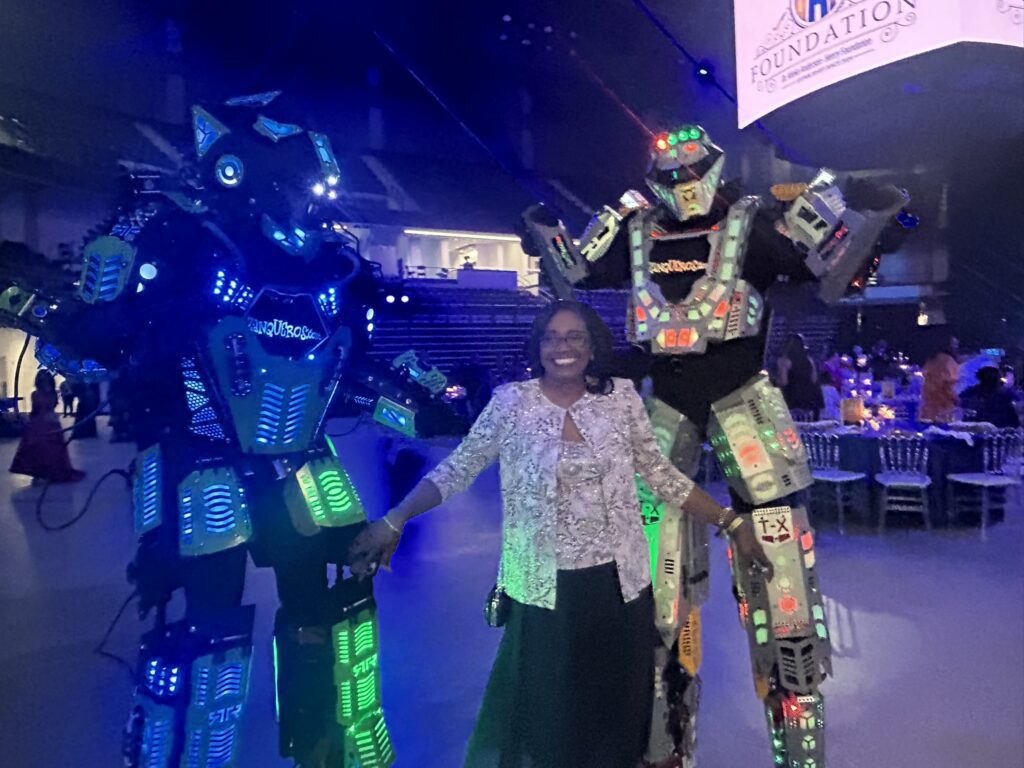Smiling woman between two illuminated robots